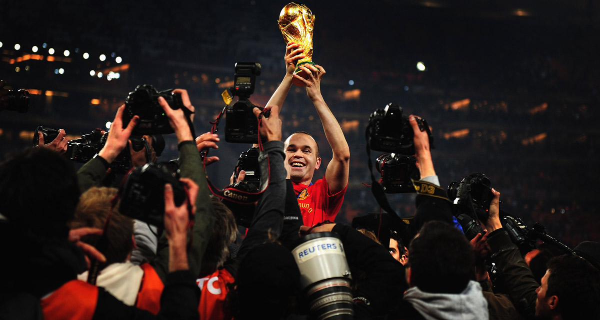 Andres Iniesta holding the world cup trophy